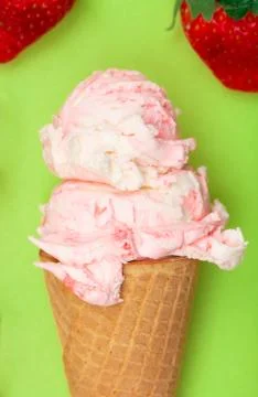 Double Scoop of Strawberry Ice Cream in a Waffle Cone on a Green Background Stock Photos