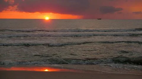 Double sea sunset with boat on horizon Stock Photos