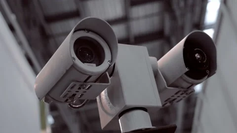 Double security cameras in metal case is checking the surrounding area Stock Footage 98228104