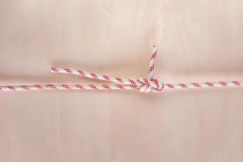 Double sheet bend ship knot on wooden background Stock Photos