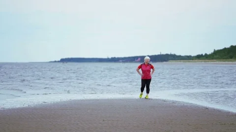 Double shot. End and start jogging. Runner sports woman among the beach stop Video stock 82415015