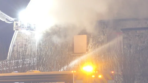 Double shot of modern fire dept's articulated platform in function at night Stock Footage 102484776