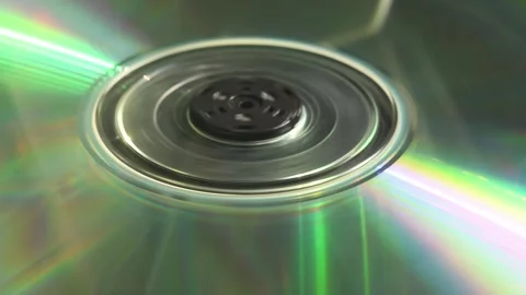 Double-sided CD stalls after short spin inside tray as person loads it, Stock Footage 305573834