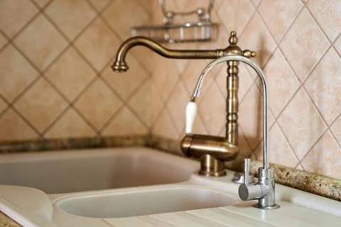 Double sink with two taps built into a white kitchen table Stock Photos