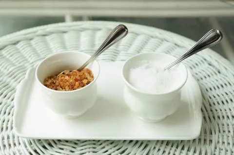 Double small cups sugar, brown and white sugars. Stock Photos