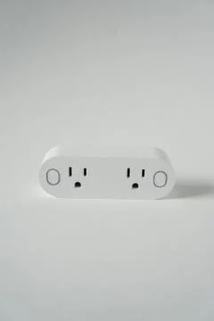 This double smart WIFI plug outlet can switch an electric device on or off vi Stock Photos