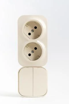 Double socket and two-key light switch on white background. Stock Photos