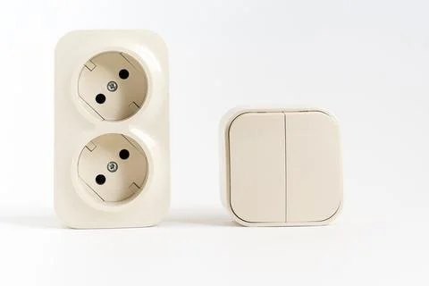 Double socket and two-key light switch on white background. Stock Photos