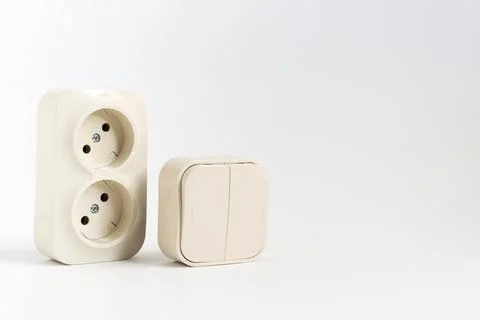 Double socket and two-key light switch on white background. Stock Photos