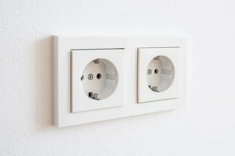 Double socket, new electric plug on white wall - Stock Photos