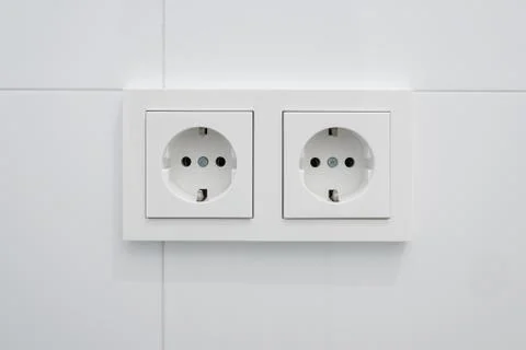 Double socket, new electric plug on white tiles Stock Photos