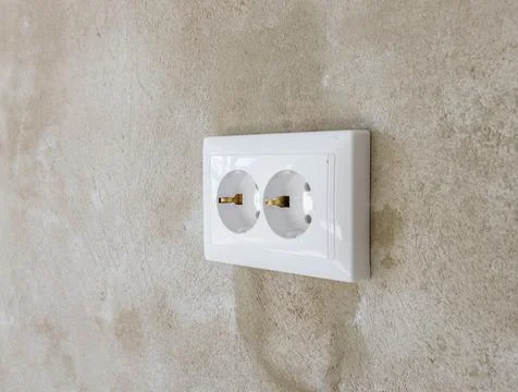Double socket on the wall in the loft style in the apartment or office Stock Photos