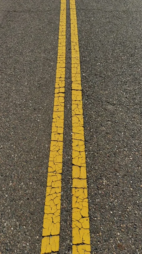 Double Solid Yellow Lines on Weathered Asphalt Stock-Footage 329829710