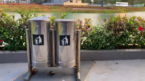 Double trash can on the lake at evening time Stock Footage 253412966