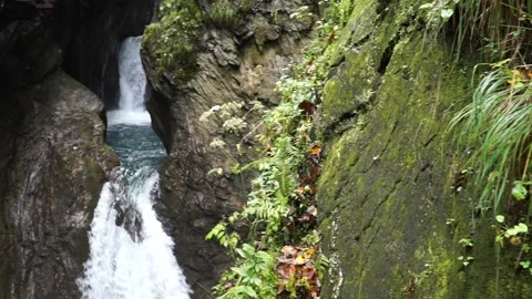 Double waterfall between rocks in the mountains with mossy stones Stock Footage 218574384