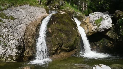 Double waterfall splashing into a pond in the evening sun Stock-Footage 260817509
