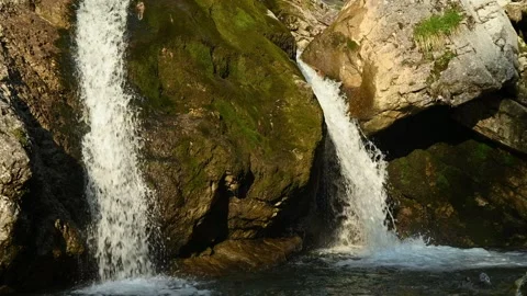 Double waterfall splashing into a pond in the evening sun Stock-Footage 260817510