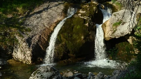 Double Waterfall splashing into a pond in the evening sun Video stock 260817585