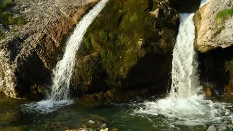 Double Waterfall splashing into a pond in the evening sun Video stock 260932231