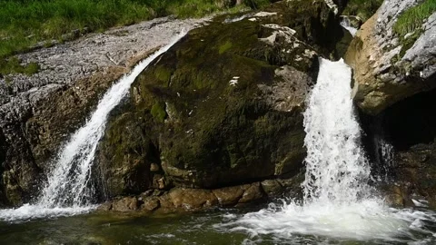 Double waterfalls splash into a pond after sunset in slowmotion 스톡 동영상 260820933