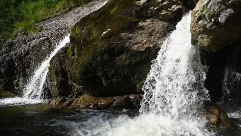 Double waterfalls splash into a pond after sunset in slowmotion Stock-Footage 260822445