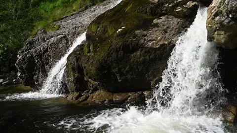 Double waterfalls splash into a pond at sunset in slow motion Stock-Footage 260822447