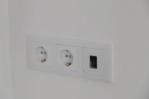 Double white electrical wall sockets on a clean interior wall Stock Photos
