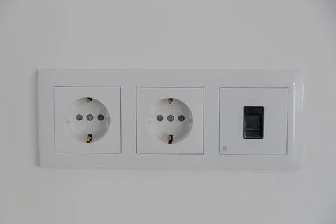 Double white electrical wall sockets on a clean interior wall Stock Photos
