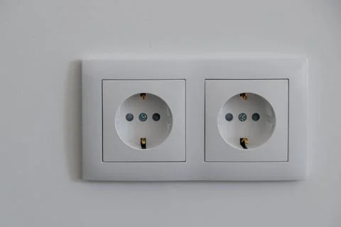 Double white electrical wall sockets on a clean interior wall Stock Photos