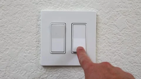 Double White Light Switches On White Wall Turing On and Off With Finger Video stock 248701843