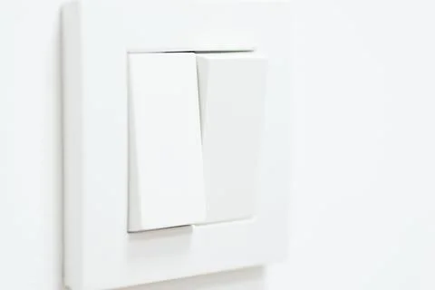 Double white mechanical switch on white wall, close up, copy space Stock Photos