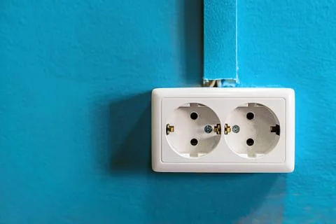 Double white rosette on blue painted wall. Copy space. Stockfoto's