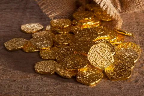Doubloons spilling from sack Stock Photos
