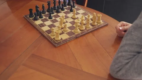 Doubt and strategy. Senior man meditates about next move in chess game Stock Footage 170695519