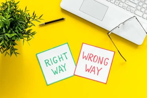 Doubt concept.. Right and wrong way icons on work desk from above 스톡 사진