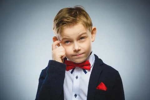 Doubt, expression and people concept - boy thinking over gray background Stock Photos