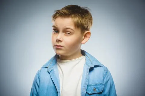 Doubt, expression and people concept - boy thinking over gray background Stock Photos