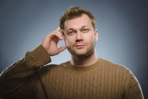 Doubt, expression and people concept - man thinking over gray background Stock Photos