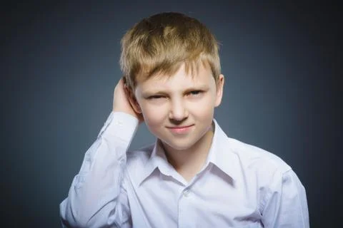 Doubt, expression and people concept - boy thinking over gray background Stock Photos