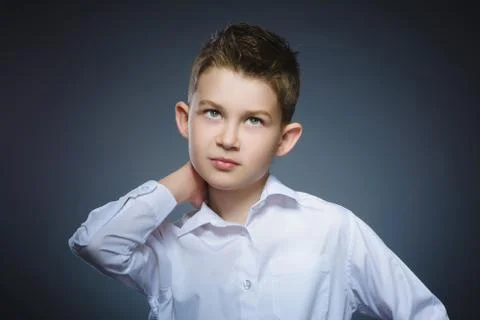 Doubt, expression and people concept - boy thinking over gray background Stock Photos