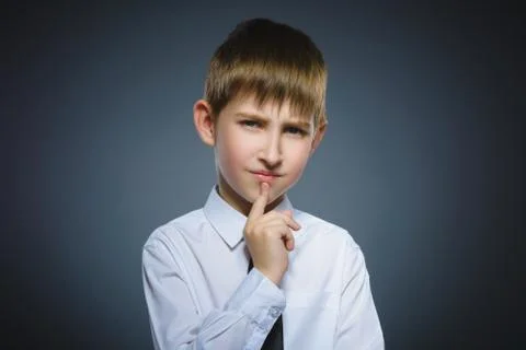 Doubt, expression and people concept - boy thinking over gray background Foto stock