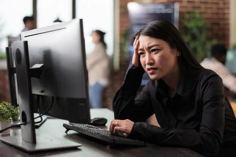 Doubtful asian computer engineer puzzled by nonfunctional security algorithm Stock Photos