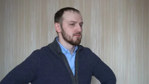 Doubtful bearded young man looking with mistrust. Man suspects someone. Stock Footage 103130501