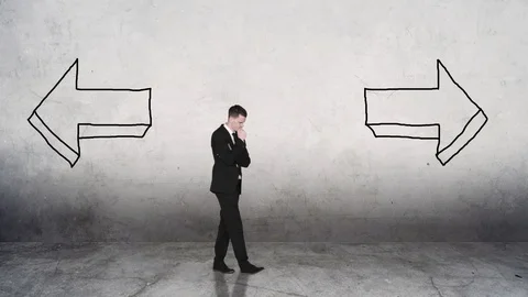 Doubtful businessman choose between two arrows Stock Footage 130061317