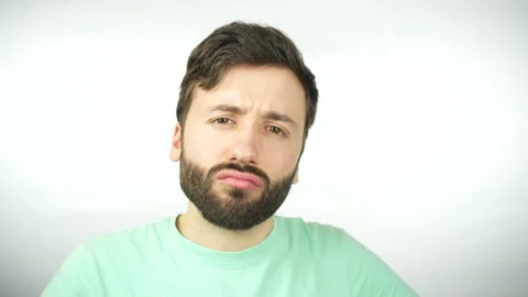 Doubtful man scratching his head while looking at the camera. Stock Footage 260115822