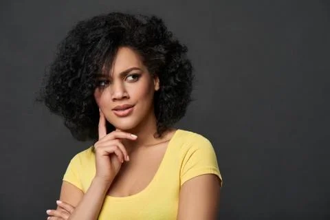 Doubtful wooman looking to side contemplating Stock Photos