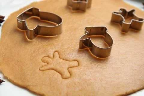 Dough and cookie cutters on white table, closeup. Christmas biscuits Stock Photos