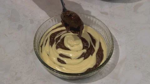 The dough with and without cocoa is laid out in a mold Stock Footage 164500840
