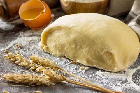 Dough, baking background. Raw dough ball for bread or pizza. Stock Photos