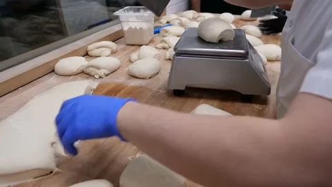 The dough is being kneaded to make pizza. The chef uses his hands to manipulate  Stock Footage 171736754